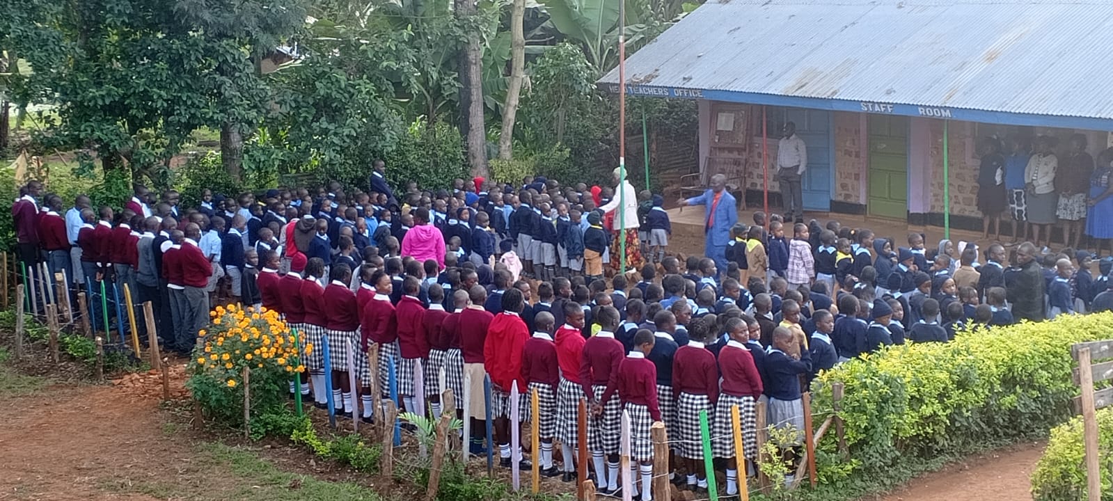 Whole school gathered for morning assembly around the flag pole